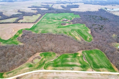 Aerial overview of property's location with a golf course
