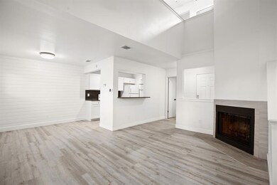 Unfurnished living room featuring baseboards, lig