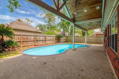 This backyard features a pool with a surrounding p