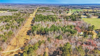 Birds eye view of property featuring a view of tre