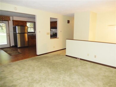 Living room opens to the dining and kitchen areas