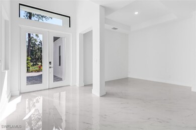 Doorway featuring light tile patterned floors, fre