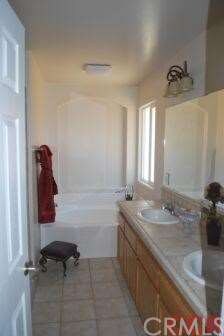 large master bath with separate tiled shower and s