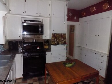 Large country style kitchen with gas stove, lots o