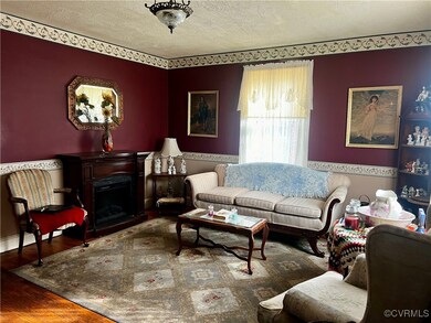 Living room featuring a textured ceiling and hardw