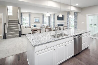 Complete open concept on the main level with the kitchen opening to the dining area and great room!  *Photos of a current Model*