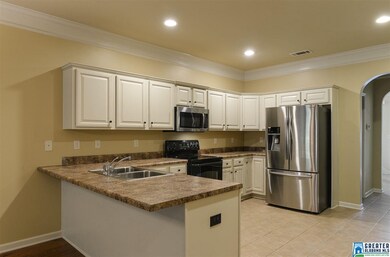 A serving island separates the kitchen from the fa