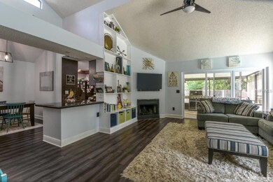 Living Room with high ceilings, built-ins & slider