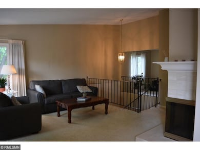 Open concept with vaulted ceilings and fireplace.