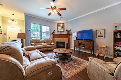 Living area with wood finished floors, ceiling fan