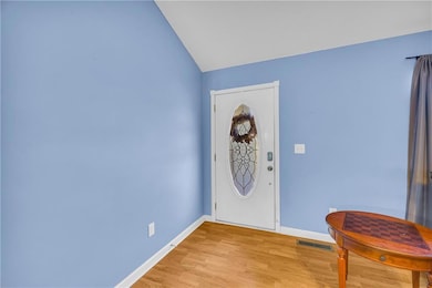 Entryway with lofted ceiling and light wood finished floors