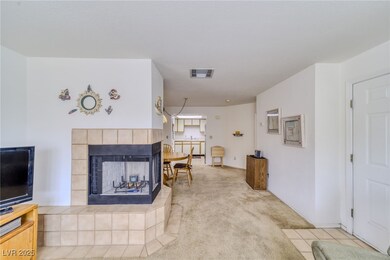 Living area with a tile fireplace, light colored c