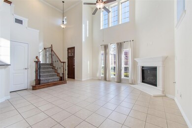 Unfurnished living room featuring a high ceiling, 
