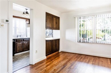 Galley kitchen opens into dining space and could be further enlarged by this home's future owner.