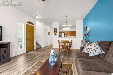Living room featuring baseboards, wood finished fl
