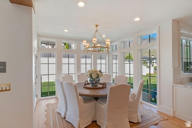 Dining room with an inviting chandelier and light wood-type flooring