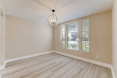 The formal dining room is at the front of the home to the right of the main entry and features vinyl plank floor and triple window overlooking the front yard.