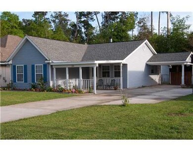 Photo. Inviting covered front porch and single car