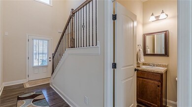 Foyer entrance with dark wood finished floors and stairway