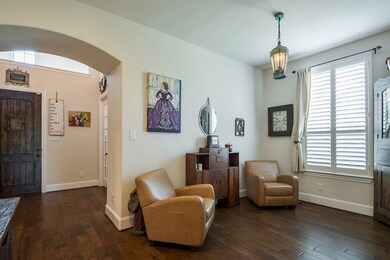 Formal dining room space off entry was staged as a sitting room in this picture