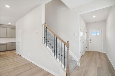 Entrance foyer with light hardwood / wood-style fl