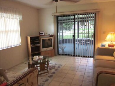 Living Room. Tiled Living Area Leading to Screened