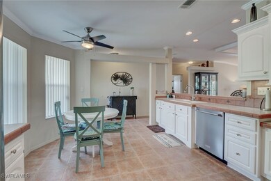 Kitchen featuring tile countertops, white cabinetr