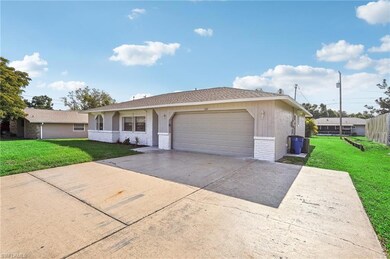 Ranch-style house featuring a front lawn and a garage