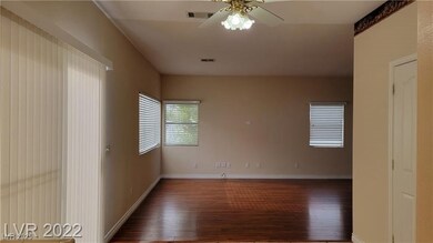Spare room with wood finished floors, ceiling fan,