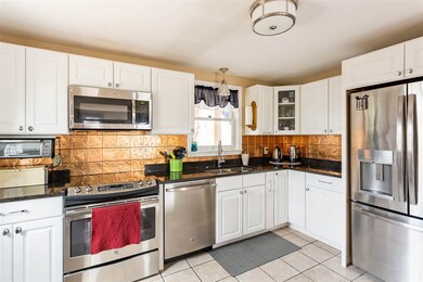 This sun filled kitchen is complete with new cabinets, drawer pulls, kitchen sink, faucet, granite countertops and stainless steel appliances.
