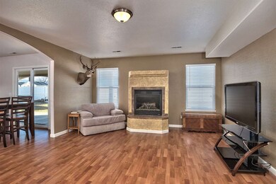 The downstairs living room boasts a cozy gas-log f