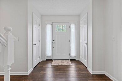 Step into the entry flooded with natural light and