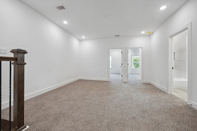 The upstairs living area features plush carpet, re