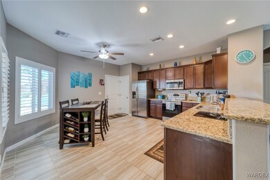 Kitchen with sink, kitchen peninsula, ceiling fan,