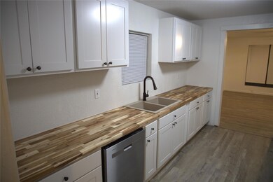 Kitchen with a sink, dishwasher, light wood-style 