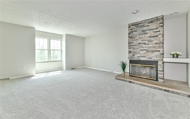 Nice sized living room features cozy gas log stack