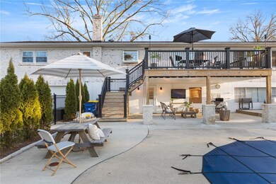 Plenty of patio room for pool-side seating with privacy landscaping arborvitae trees