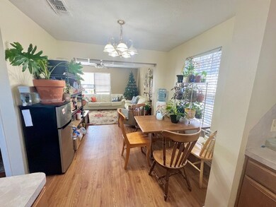 Dining area with visible vents, light wood-style f