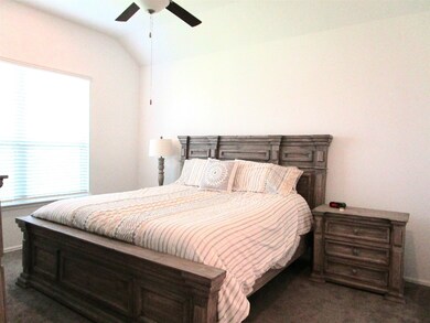 Primary bedroom offers ceiling fan