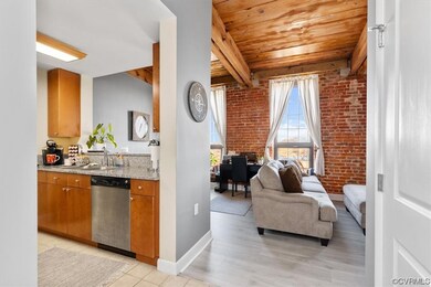 Kitchen featuring stainless steel dishwasher, wood