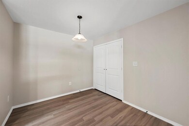 Empty room featuring dark hardwood / wood-style flooring