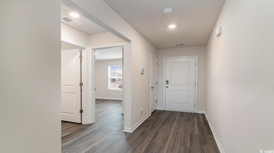 Hall with dark wood-type flooring