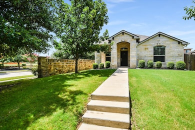 French country inspired facade featuring stone si