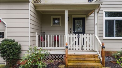Doorway to property featuring covered porch
