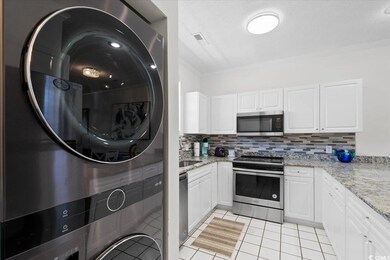 Kitchen with visible vents, white cabinetry, appli