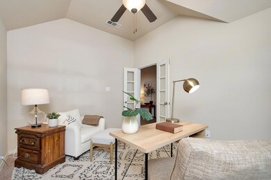 Carpeted office featuring ceiling fan and lofted c