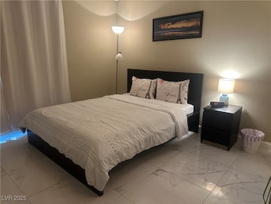 Bedroom with marble finish floor and baseboards