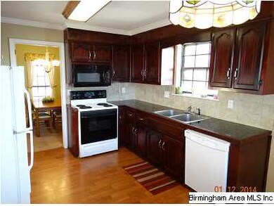 Eat- Kitchen with hardwood laminate floors, backsp