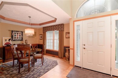Adjacent to the foyer is the formal dining room with a trayed ceiling and hardwood bordered floor.
