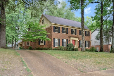 Colonial home with a front yard